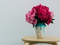 Red peonies in a handmade vase