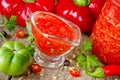 Red pepper adzhika in glass gravy boat Royalty Free Stock Photo