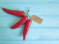 Red pepper on a blue wooden background spice tag Royalty Free Stock Photo