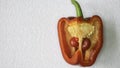 Red pepper cut in half with small paprika inside,white background