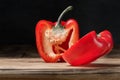 Red pepper cut into two pieces on wooden cutting board Royalty Free Stock Photo
