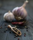 Red pepper garlic wood table scatter spice rustic kitchen cooking close up macro Royalty Free Stock Photo
