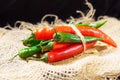 Red pepper and green, on dark wooden board, selective focus. Organic food concept Royalty Free Stock Photo