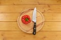 Red pepper with a knife on a chopping board Royalty Free Stock Photo