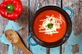 Red pepper soup overhead scene on rustic blue wood background Royalty Free Stock Photo