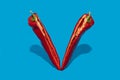 Red pepper split on half standing on blue background Royalty Free Stock Photo