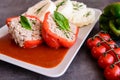 Red pepper stuffed with rice, minced meat and vegetable in tomato sauce with steamed dumpling Royalty Free Stock Photo