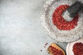 Red peppercorn seed in granite mortar or pestle Royalty Free Stock Photo