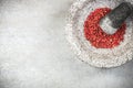Red peppercorn seed in granite mortar or pestle