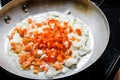 Red peppers and onions sauteing in fry pan