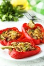 Red peppers stuffed with meat, rice and vegetables on a white wooden background Royalty Free Stock Photo