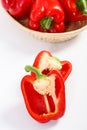 Red peppers with wicker basket on white background, concept of healthy nutrition Royalty Free Stock Photo