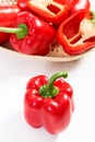 Red peppers with wicker basket on white background, concept of healthy nutrition Royalty Free Stock Photo