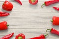 Red peppers on wooden kitchen desk. Free space in the middle for text or logo promotion