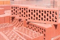 Red perforated bricks with rectangular holes closeup