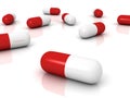 Red pharmaceutical capsules pills on white surface