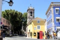 Red phone booth and colorful residential and commercial buildings in the historic heart of Sintra, Portugal