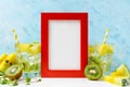 Red Photo frame mockup: cool and fresh kiwi watermelon lemonade with ingredients on blue background. Vegetarian food, healthy life