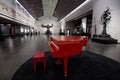 A red piano inside the showroom