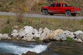 Red pick-up and river landscape