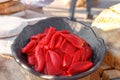 Red pickled Bulgarian pepper lies in a metal bowl