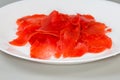 Red pickled sliced ginger on dish on a gray background Royalty Free Stock Photo