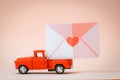 red pickup retro toy car delivering mail and love letters and flowers. Royalty Free Stock Photo