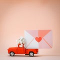 red pickup retro toy car delivering mail and love letters and flowers. Royalty Free Stock Photo