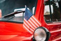 Red Pickup Truck With Small American Flag Waving. Close Side View Of Red Pickup Truck American Flag Waving. 4th of July Royalty Free Stock Photo