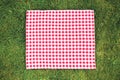 Red picnic square cloth on green grass top view,food advertisement display Royalty Free Stock Photo