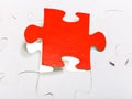 Red piece attached in assembled puzzles Royalty Free Stock Photo