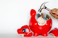 Red piggy bank breaking by the hammer with Thai baht bank note inside Royalty Free Stock Photo