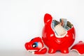 Red piggy bank breaking with Thai baht bank note inside Royalty Free Stock Photo