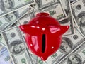 Red piggy bank on dollars. Savings and investments in American economy Royalty Free Stock Photo