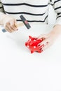 Red piggy bank and hammer held by woman