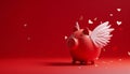 Red piggy bank with white angelic wings as a cupid, on solid red background. Heart shaped confetti flying in air.