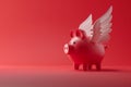 Red piggy bank with white angelic wings as a cupid, on solid red background