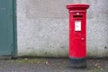 Red pillar post box for mail collection Royalty Free Stock Photo