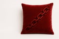 A red pillow with an embroidered chain. Space for text. Royalty Free Stock Photo