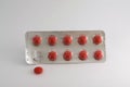 Red pills blister isolated. One pill is removed from tha pack. Royalty Free Stock Photo