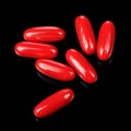 Red Pills (Capsules) on Black Background Royalty Free Stock Photo