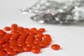 Red pills lying on white table with empty blister packs Royalty Free Stock Photo