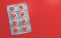 Red pills in the shape of a heart in a blister. Pill packaging on a red background. Creative concept. Copy space. 3D render