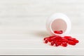 Red pills spilled around a pill bottle. Medicines and prescription pills flat lay background. Red medical capsules Royalty Free Stock Photo