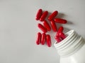 Red pills, red vitamins, red pills on a warm white background, look clean. Vit B