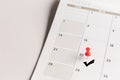 Red pin and arrow symbol on calendar