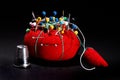 Red Pin Cushion on Black Background Royalty Free Stock Photo