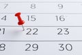 Red pin on the date 22th on the calendar close-up. Important date. Place for text.