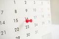 A red pin on the event calendar.background, close up, time Royalty Free Stock Photo