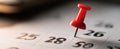 The red pin marking an important date on the calendar. AI generated image Royalty Free Stock Photo